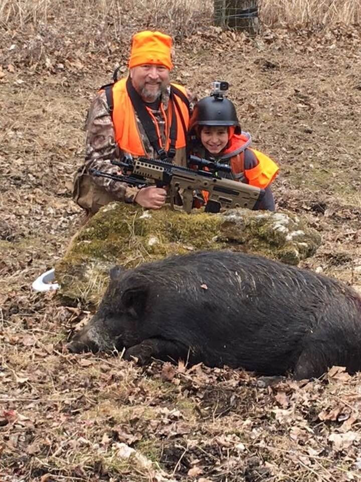 Young hunter with his first wild boar