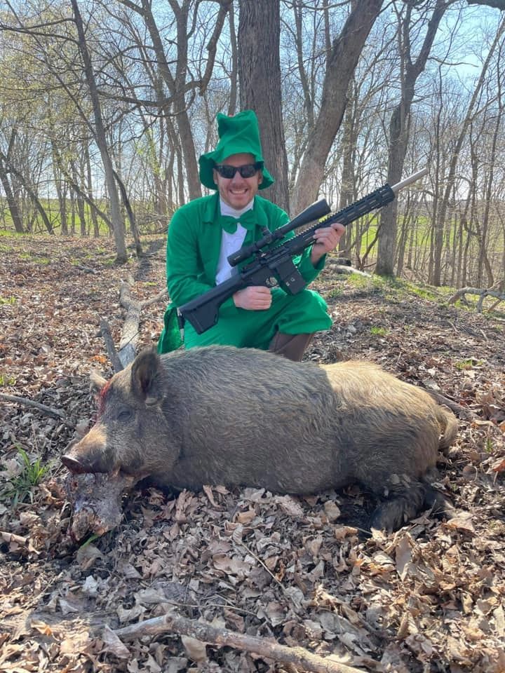 Hunter holding a harvested stag in the field