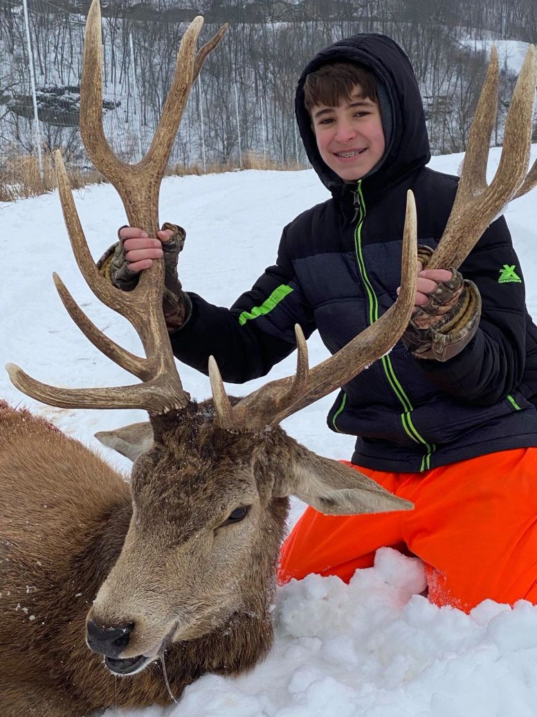 Father and son with a beautiful red stag
